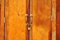Close up on the lock key with wooden door Royalty Free Stock Photo