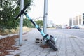 Locked electric kick scooter in urban street