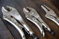 Close up locking pliers on wooden background, Hand tools in work shop Royalty Free Stock Photo