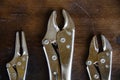 Close up locking pliers on wooden background, Hand tools in work shop Royalty Free Stock Photo