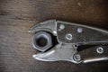 Close up locking pliers on wooden background, Hand tools in work shop