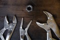 Close up locking pliers on wooden background, Hand tools in work shop