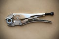 Close up locking pliers on wooden background, Hand tools in work shop Royalty Free Stock Photo