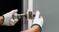 Locksmith repairing a broken door knob Royalty Free Stock Photo