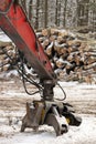 Close up of Log Grapple on Knuckleboom Log loader with Freshly Harvested and piled timber logs