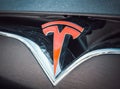 Close up with the logo of the famous american luxury electric car brand Tesla