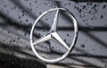 Close up of the logo of Mercedes-Benz on the car front