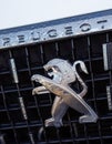 Close-up of the logo placed on the front bumper of the white Peugeot SUV car