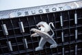 Close-up of the logo placed on the front bumper of the white Peugeot SUV car