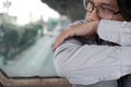 Close up lonely depressed Asian man sit and hug his knee on the floor Royalty Free Stock Photo