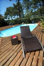 Close-up of long chairs by the swimming pool