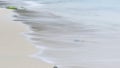 Close Up long exposure of and ocean wave on the sand Royalty Free Stock Photo