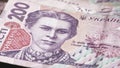 A close-up look at a 200 Ukrainian hryvnia banknote reveals the captivating portrayal of Lesya Ukrainka, showcasing the intricate
