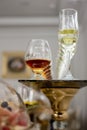 Close up of lot of glasses of fresh cognac and champagne on bar table.