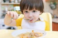 Close up of lovely little boy eating soup Royalty Free Stock Photo