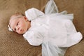 Close-up lovely newborn baby girl on a blanket. A portrait of a beautiful  newborn baby girl wearing a headband. Closeup photo Royalty Free Stock Photo