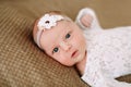 Close-up lovely newborn baby girl on a blanket. A portrait of a beautiful  newborn baby girl wearing a headband. Closeup photo Royalty Free Stock Photo