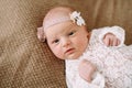 Close-up lovely newborn baby girl on a blanket. A portrait of a beautiful  newborn baby girl wearing a headband. Closeup photo Royalty Free Stock Photo