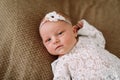 Close-up lovely newborn baby girl on a blanket. A portrait of a beautiful  newborn baby girl wearing a headband. Closeup photo Royalty Free Stock Photo