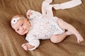 Close-up lovely newborn baby girl on a blanket. A portrait of a beautiful  newborn baby girl wearing a headband. Closeup photo Royalty Free Stock Photo