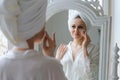 Close-up lovely woman after shower takes care clean skin and pores, holds Royalty Free Stock Photo