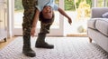 Close Up Of Loving Army Father In Uniform Home On Leave Holding Son Upside Down