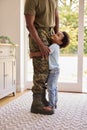 Close Up Of Loving Army Father In Uniform Home On Leave With Son Standing On Feet