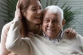 Close up loving elderly father stroking overjoyed daughter head Royalty Free Stock Photo