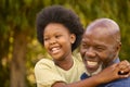 Close Up Of Loving Grandfather Laughing And Hugging Granddaughter Outdoors In Countryside Or Garden