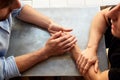 Close Up Of Loving Male Gay Couple Sitting At Table In Coffee Shop Holding Hands