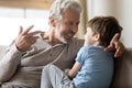 Close up loving mature grandfather chatting with adorable grandson