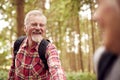 Close Up Of Loving Retired Senior Couple Holding Hands Hiking In Woodland Countryside Together Royalty Free Stock Photo