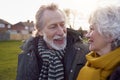 Close Up Of Loving Senior Couple Enjoying Autumn Or Winter Walk Through Park Together Royalty Free Stock Photo