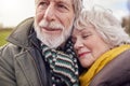 Close Up Of Loving Senior Couple Enjoying Autumn Or Winter Walk Through Park Together Royalty Free Stock Photo