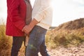 Close Up Of Loving Senior Couple Holding Hands Walking Through Sand Dunes On Winter Vacation Royalty Free Stock Photo