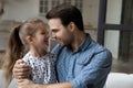 Close up loving smiling father hugging little daughter at home Royalty Free Stock Photo