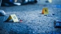 Close Up Low Angle Shot of Evidence Scattered at Crime Scene. Bloodied Glasses, Bloody Knife and Royalty Free Stock Photo