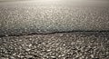 Asphalt Road Surface Texture with Sunlight Reflections Royalty Free Stock Photo