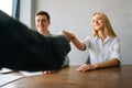 Close-up low-angle view of excited smiling caucasian business people handshaking greet each other at meeting. Satisfied Royalty Free Stock Photo