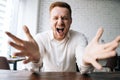 Close-up low-angle view of excited young business man screaming in joy, feeling happy receiving new job opportunity Royalty Free Stock Photo