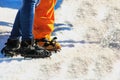 Close up of lower legs of two travelers starting climb to glacier. Feet of couple in love in shoes crampons on glacial trail. Royalty Free Stock Photo