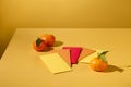 Close up of lucky money envelopes displayed on a yellow background with tangerines. Space for display and design. New Year theme.