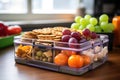 close-up of a lunchbox with diverse healthy snacks on a students desk