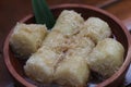 a close up of lupis with grated coconut and brown sugar sauce
