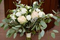 Close up of lush wedding bouquet of white flowers and greenery on wood background, copy space. Royalty Free Stock Photo