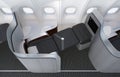 Close-up of luxurious business class seat with frosted acrylic partition.