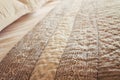 Close up of luxury bed quilt cover and pillows horizontal Royalty Free Stock Photo
