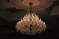 Close up luxury crystal chandelier hanging under ceiling in the room. Royalty Free Stock Photo