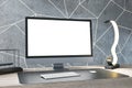Close up of luxury designer desk top with empty white computer monitor, various items and light concrete wall. Mock up, 3D
