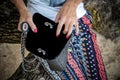 Close up of luxury handmade snakeskin python handbag in woman hands. Tropical Bali island. Royalty Free Stock Photo